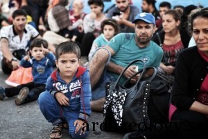 TOPSHOTS Newly arrived Syrian migrants wait in the port of Kos to be registered on the Eleftherios Venizelos liner on August 17, 2015. Authorities on the island of Kos have been so overwhelmed that the government sent a ferry to serve as a temporary centre to issue travel documents to Syrian refugees -- among some 7,000 migrants stranded on the island of about 30,000 people. The early hours are the safest time for migrants travelling from Turkey to the Greek islands just across the water, which have seen a huge influx of refugees escaping the civil war in Syria and chaos in Afghanistan since the beginning of this year. AFP PHOTO /LOUISA GOULIAMAKI